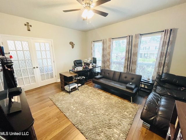 living area with ceiling fan, french doors, and wood finished floors