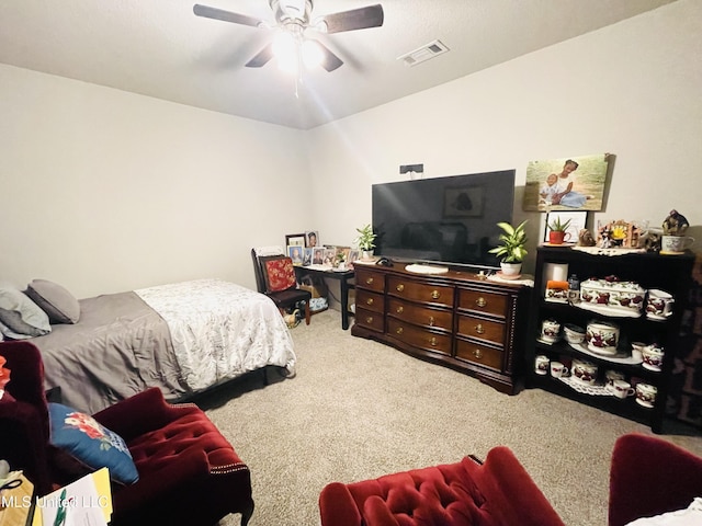 carpeted bedroom featuring visible vents and ceiling fan