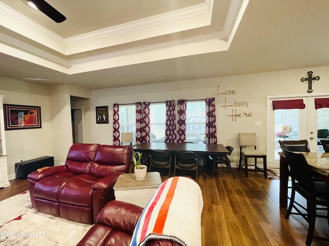 living area featuring a tray ceiling, crown molding, dark wood-style flooring, and french doors