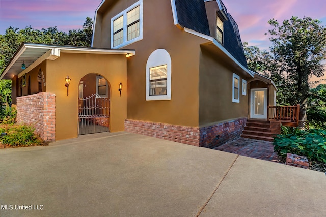 view of property exterior at dusk