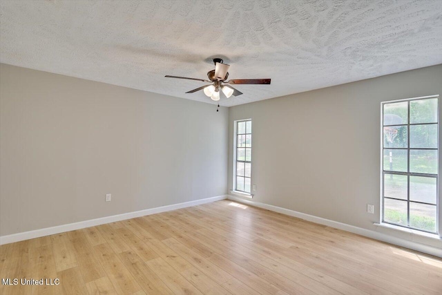 800 Longwood Pl, Clinton, MS 39056 - empty room featuring light wood-style flooring, a ceiling fan, plenty of natural light, baseboards, and a textured ceiling