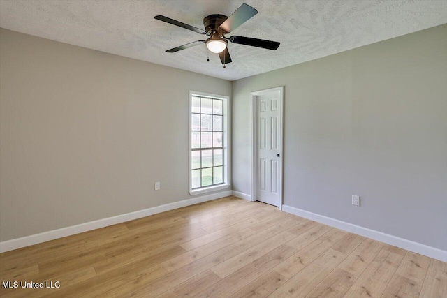 800 Longwood Pl, Clinton, MS 39056 - empty room featuring light wood-type flooring, baseboards, ceiling fan, and a textured ceiling