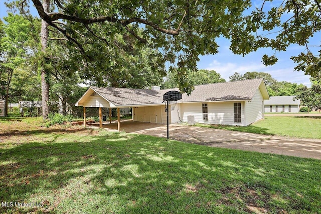 800 Longwood Pl, Clinton, MS 39056 - back of property with concrete driveway, a carport, and a lawn