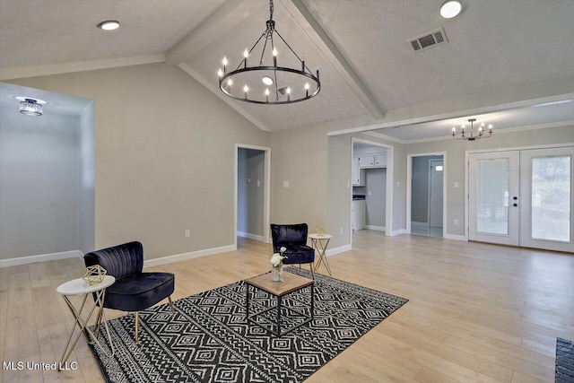 800 Longwood Pl, Clinton, MS 39056 - living area featuring a chandelier, light wood-style flooring, baseboards, a textured ceiling, and french doors