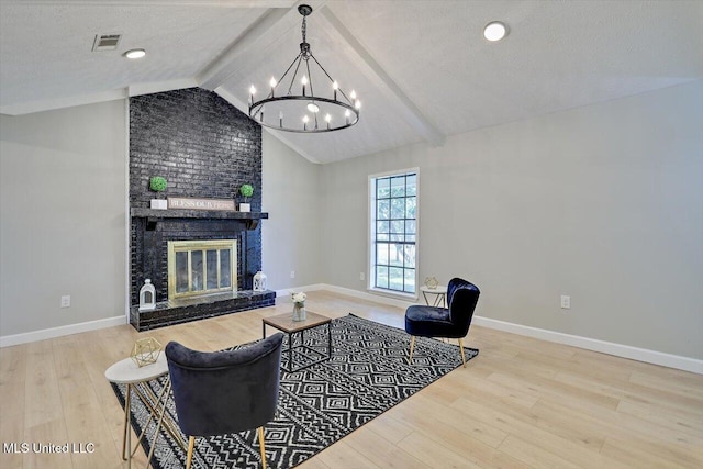 800 Longwood Pl, Clinton, MS 39056 - living area featuring a chandelier, wood finished floors, a fireplace, baseboards, and a textured ceiling