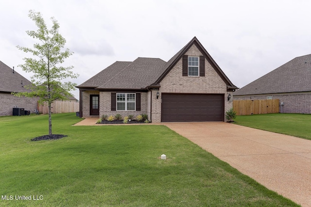 2561 Dela Dr, Southaven, MS 38672 - view of front of home featuring brick siding, driveway, roof with shingles, a garage, and cooling unit