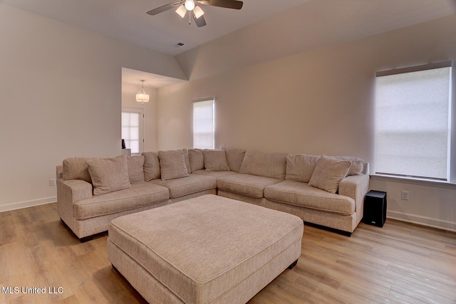 2561 Dela Dr, Southaven, MS 38672 - living room featuring light wood-type flooring, ceiling fan, baseboards, and vaulted ceiling