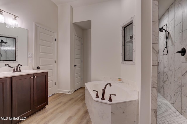 2561 Dela Dr, Southaven, MS 38672 - bathroom featuring a marble finish shower, a garden tub, vanity, and wood finished floors
