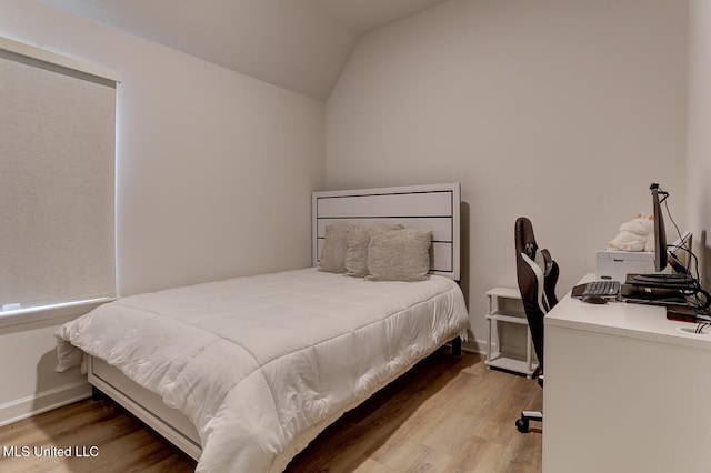 2561 Dela Dr, Southaven, MS 38672 - bedroom featuring wood finished floors, vaulted ceiling, a desk, and baseboards