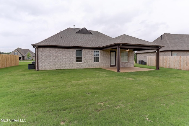 2561 Dela Dr, Southaven, MS 38672 - rear view of house with a patio area, a shingled roof, brick siding, and central AC unit