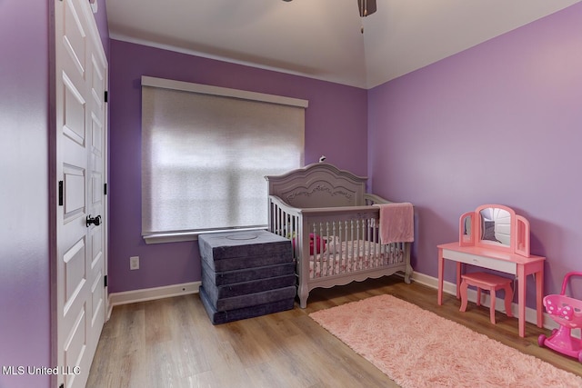 2561 Dela Dr, Southaven, MS 38672 - bedroom featuring wood finished floors, baseboards, a nursery area, and a ceiling fan