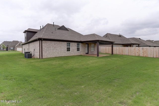 2561 Dela Dr, Southaven, MS 38672 - back of house featuring central air condition unit, brick siding, a shingled roof, and a patio area