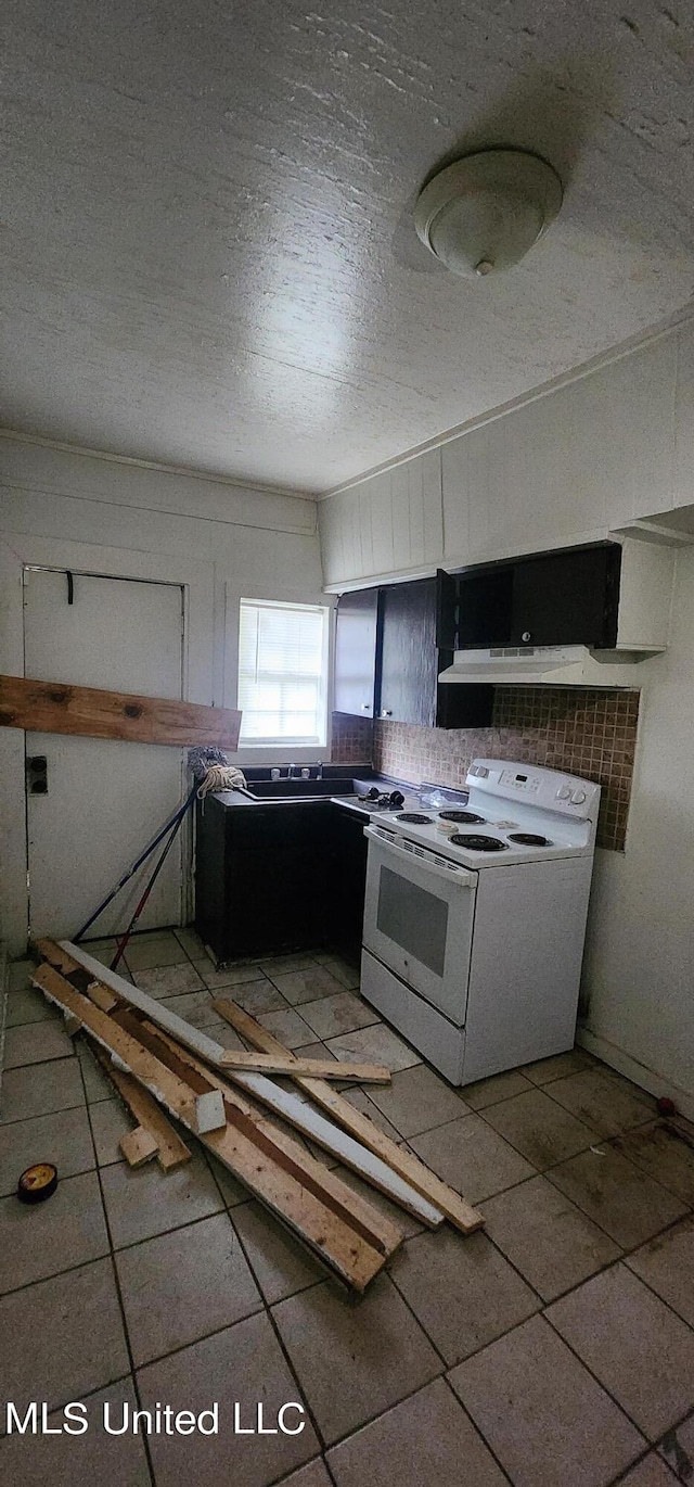 kitchen with tile patterned floors, electric range, a textured ceiling, and tasteful backsplash