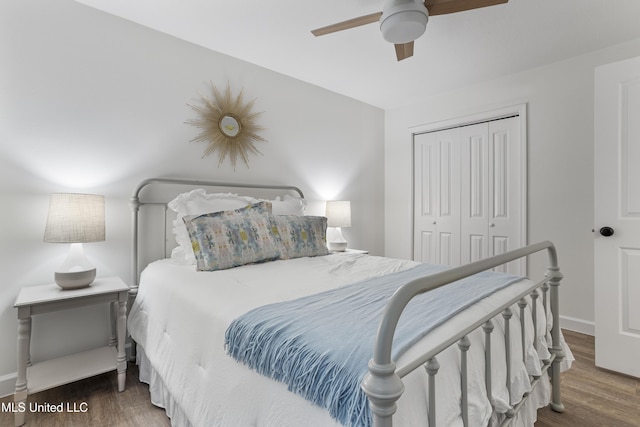 bedroom featuring a closet, ceiling fan, baseboards, and wood finished floors