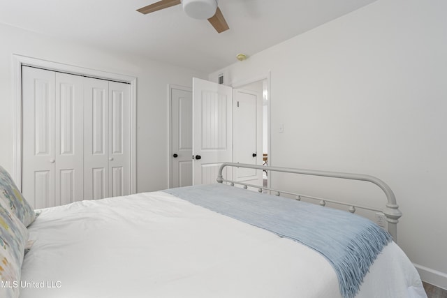 bedroom featuring a ceiling fan, a closet, and baseboards