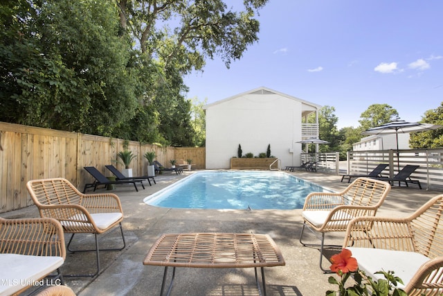 view of swimming pool featuring a patio, a fenced backyard, and a fenced in pool