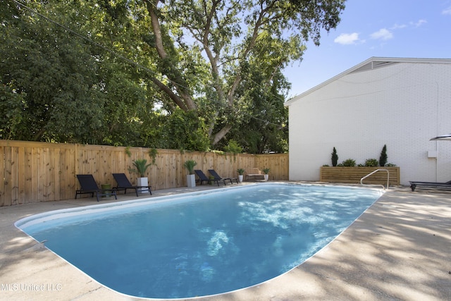 view of pool featuring a patio and fence