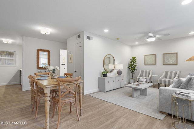 dining area with visible vents, ceiling fan, light wood-style flooring, and baseboards