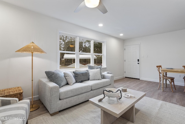 living room with a ceiling fan, recessed lighting, light wood-style flooring, and baseboards