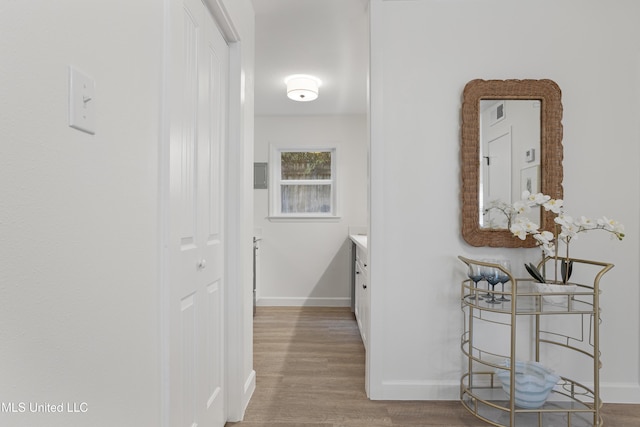 hallway with baseboards and wood finished floors