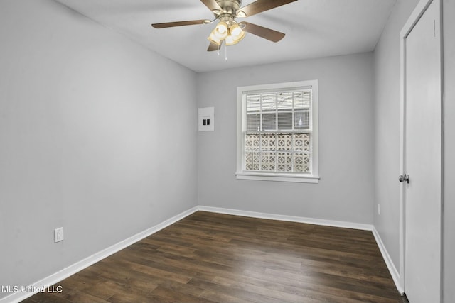 spare room with ceiling fan and dark hardwood / wood-style flooring