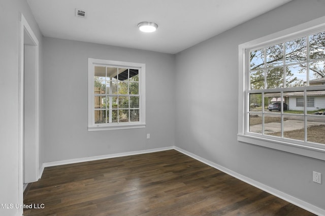 unfurnished room featuring dark wood-type flooring