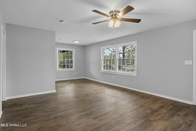 empty room with ceiling fan and dark hardwood / wood-style floors