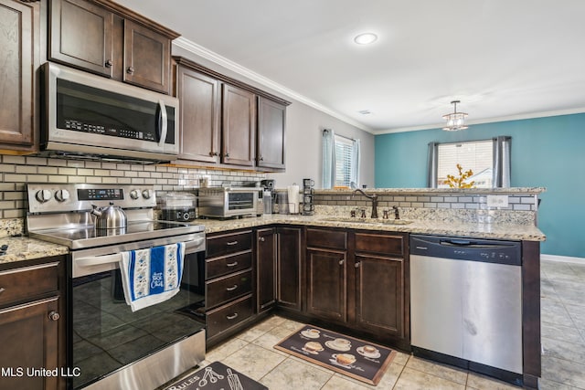 kitchen with decorative backsplash, sink, light stone countertops, appliances with stainless steel finishes, and dark brown cabinets