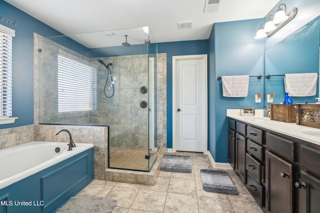 bathroom featuring separate shower and tub, vanity, and tile patterned floors