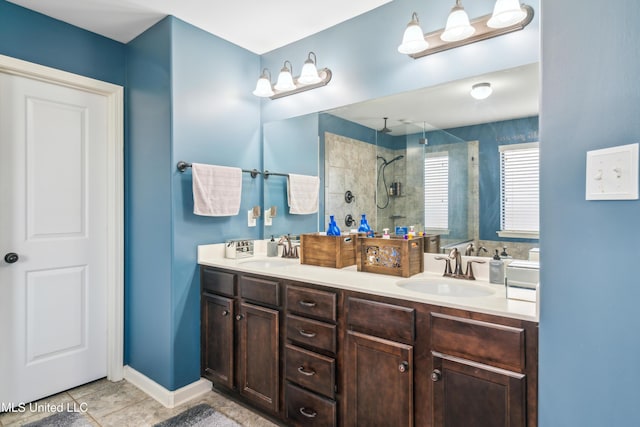 bathroom with vanity, tile patterned floors, and a tile shower