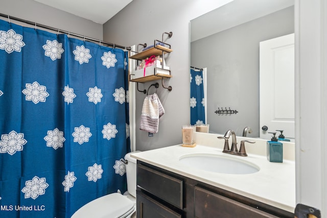 bathroom featuring toilet and vanity