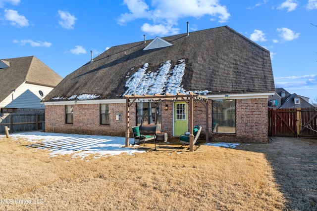 rear view of property with a yard and a pergola