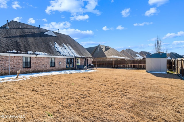 view of yard featuring a patio area and a storage shed