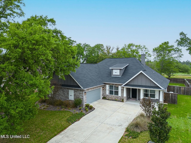 view of front of home featuring concrete driveway, fence, board and batten siding, a garage, and a shingled roof