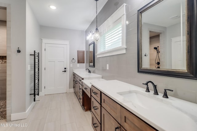 bathroom featuring vanity, decorative backsplash, baseboards, and walk in shower