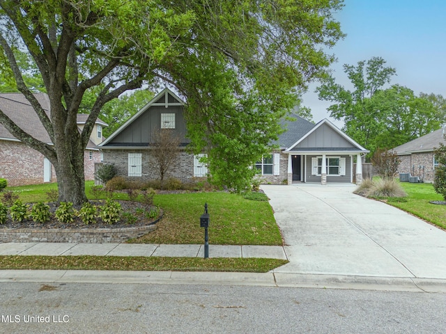 craftsman-style house featuring driveway, board and batten siding, and a front yard