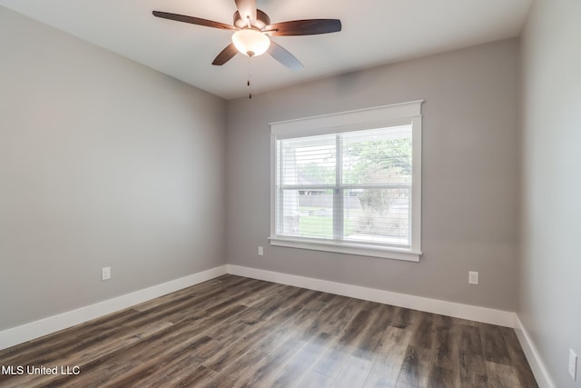 spare room featuring dark wood-style floors, baseboards, and ceiling fan