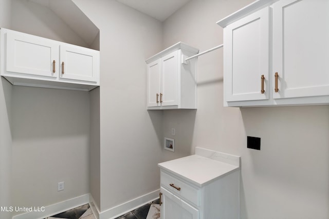 laundry area featuring hookup for a washing machine and cabinets