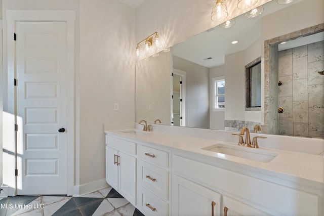 bathroom with vanity, a tile shower, and tile patterned flooring