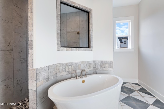 bathroom with tile patterned floors, independent shower and bath, and tile walls