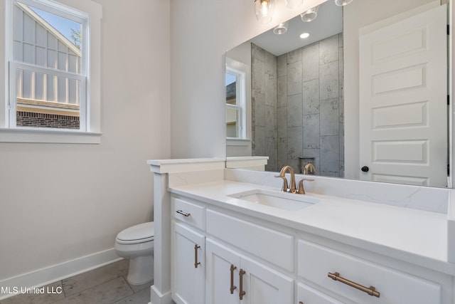 bathroom featuring vanity, toilet, and tile patterned flooring