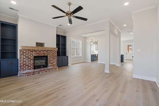 unfurnished living room with light hardwood / wood-style floors, ornamental molding, ceiling fan with notable chandelier, and a fireplace