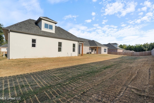 back of house featuring a lawn