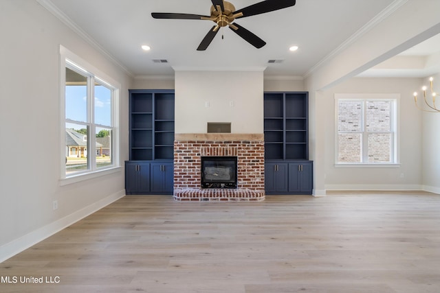 unfurnished living room featuring crown molding, a fireplace, and light wood-type flooring