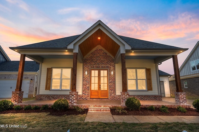 view of front of home with covered porch and a garage