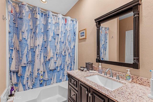 bathroom featuring vanity and shower / bath combination with curtain