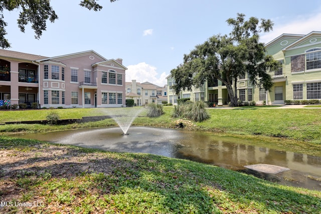 view of home's community featuring a yard and a water view