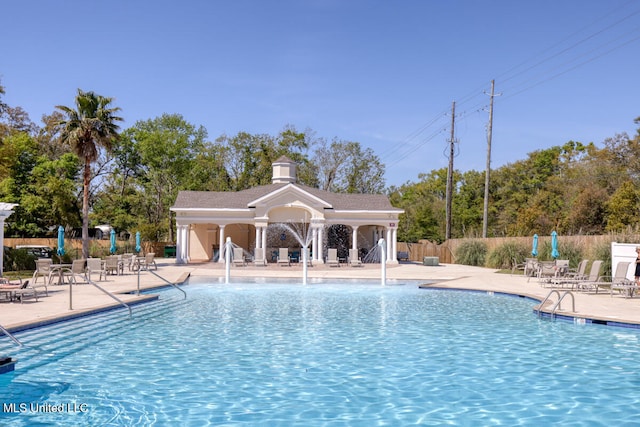 view of pool featuring pool water feature and a patio area