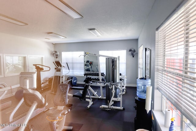 gym with a textured ceiling