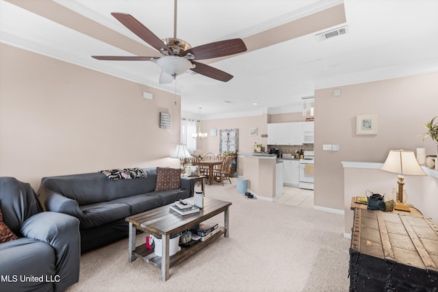 living room featuring ceiling fan with notable chandelier, light carpet, and crown molding